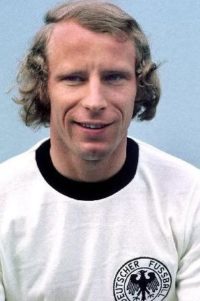 60. Berti Vogts Hans-Hubert "Berti" Vogts started his career in his hometown club VfR Büttgen. The right-sided defender was soon picked up by one of West Germany’s top clubs at the time, Borussia Mönchengladbach, where he established himself and played for fourteen years. Nicknamed “Der Terrier” for always fighting for every ball as it was his last, Vogts was a big favourite with his home crowd. In 1967, he made his debut for West Germany and three years later he took part in his first big tournament, the World Cup in Mexico. Berti played in every game as the Germans captured bronzemedals. Vogts seldom had to settle for second best at club level. His impressive roll of honour included five league championships, one domestic cup title and two UEFA Cup titles all with the same club, Borussia Mönchengladbach. On a personal note, he was named German Player of the Year twice. One trophy that eluded him was the European Cup which he came very close of winning in 1977 when his team lost 3-1 to Liverpool in the final in Rome. By then he was already a World Cup winner. Three years earlier, West Germany hosted and won the World Cup with Vogts as one of their most important players. He played in all the seven matches including the final where he was marking the Dutch star Johann Cruyff with success. He was in fact an ever-present in every of the three World Cups he participated in, making his total of games to 19, beaten by only five other players in World Cup history. In 1977, Berti took over the captaincy of the national team from Franz Beckenbauer and kept it until after the Argentina World Cup the following year which was no success for him or the team as West Germany bowed out in the second phase. He retired as a player in 1979 and started working as a scout before taking over the German national team as coach in 1990 leading them to victory in Euro 1996. A somewhat less successful period of managing the Scottish National team followed. My Football Facts & Stats Brazil's Pele My Football Facts & Stats >> Legendary Football Players >> Charles Wreford-Brown Berti Vogts